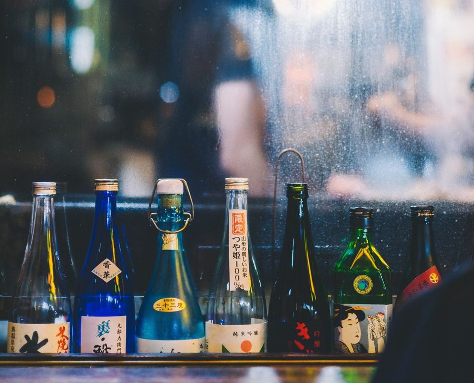 Sake bottles lined up on a bar counter in Tokyo