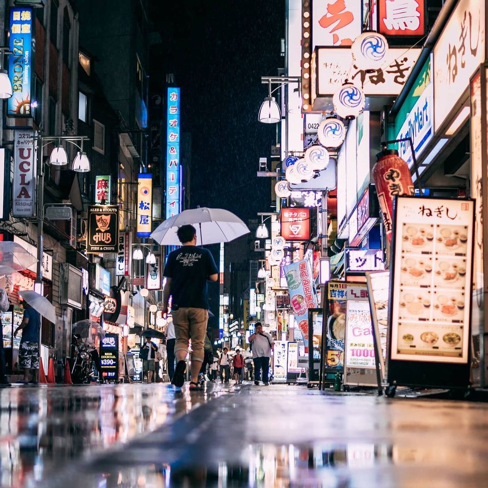 Neon-lit Tokyo street at night in the rain
